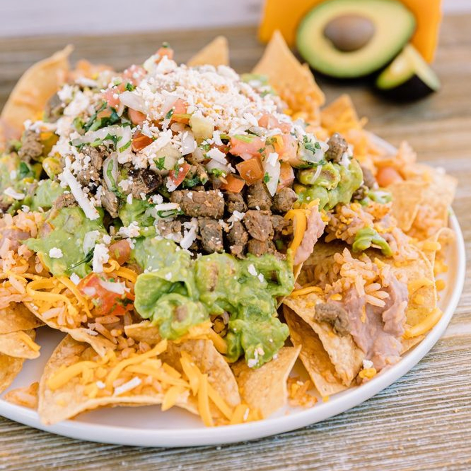 Adalbertos Mexican Food's carne asada nachos with guacamole, pico de gallo, cheese, and refried beans.